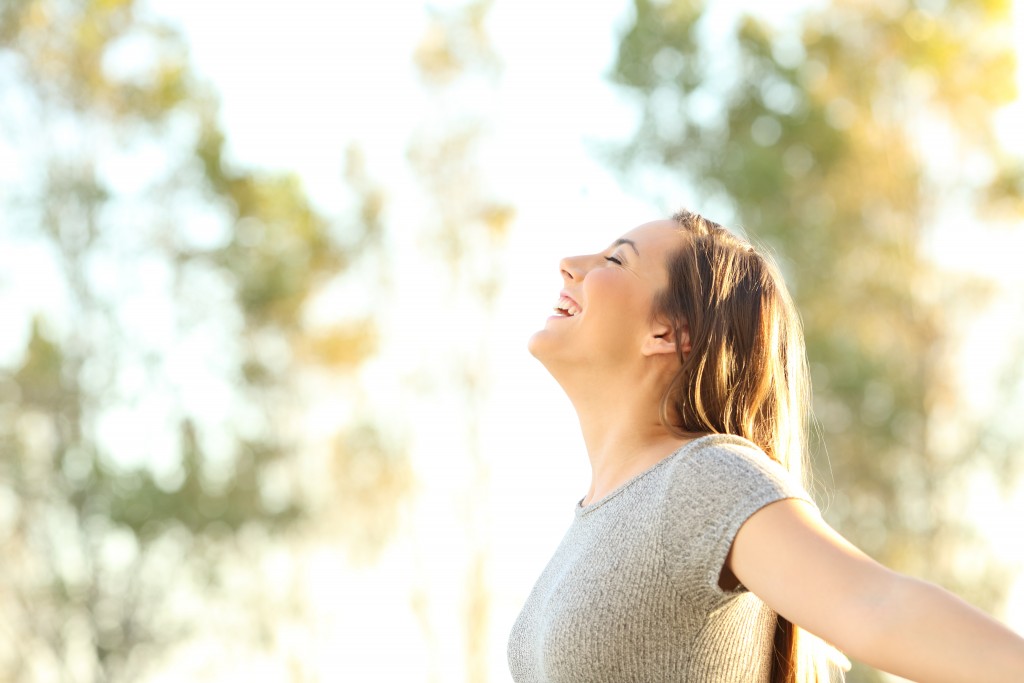 Happy female with arms wide open