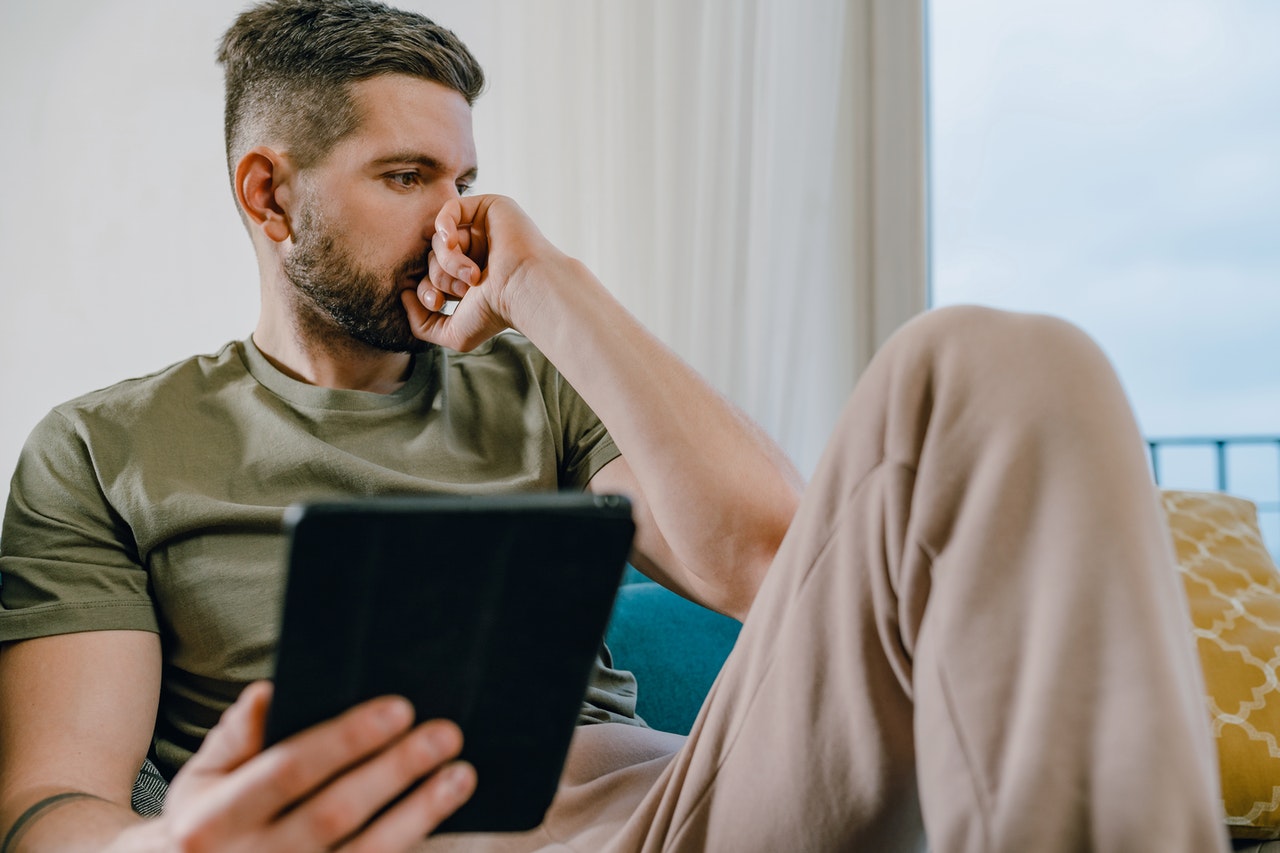 sad man holding a tablet