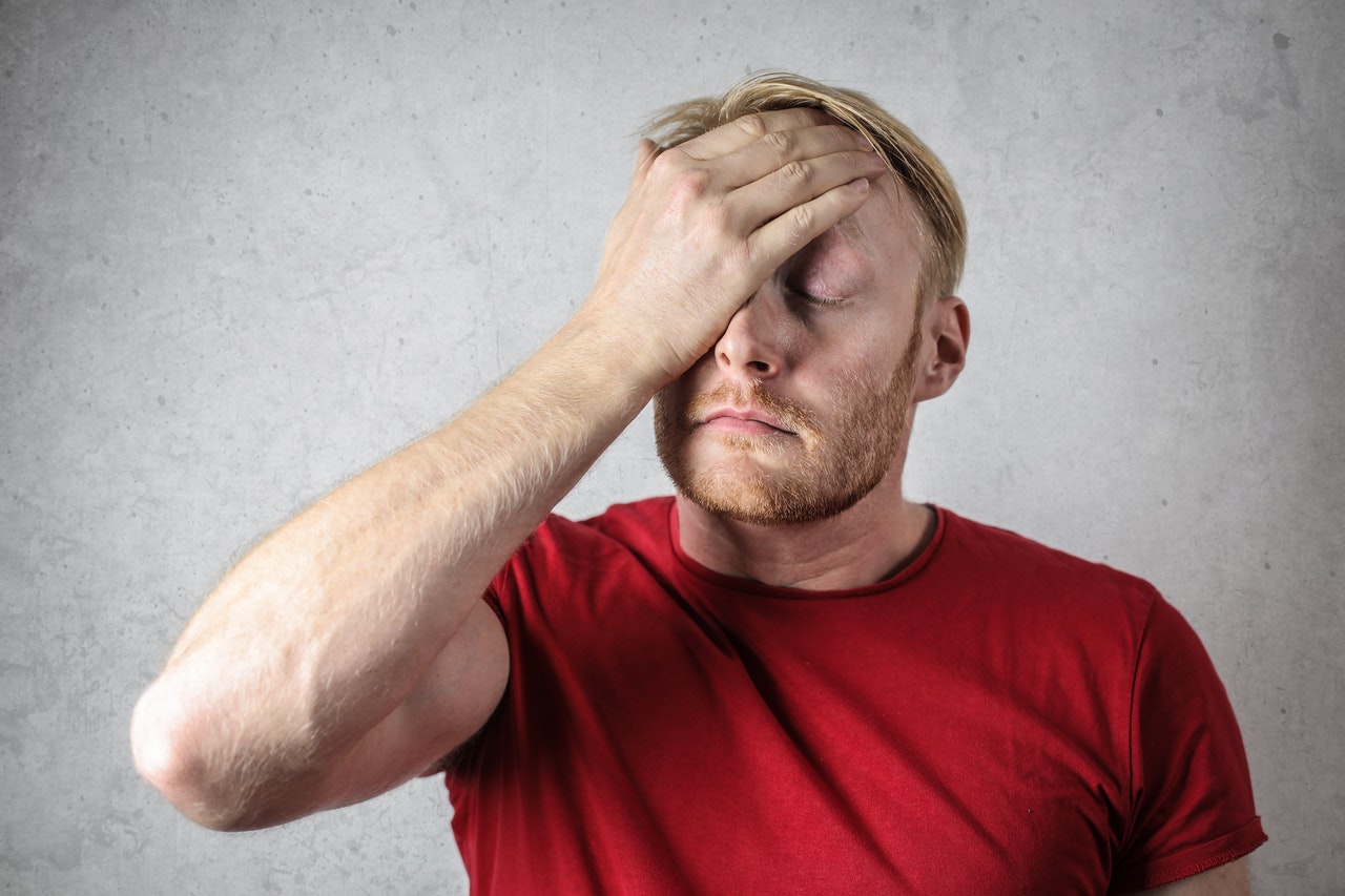 sad man wearing a red shirt