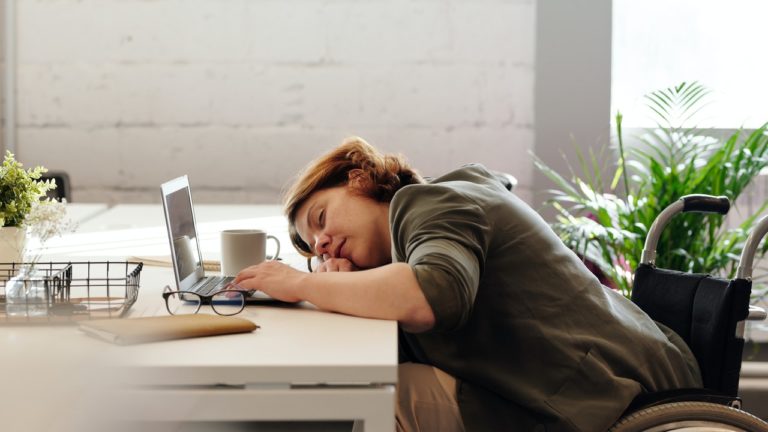 woman sleeping on desk while working