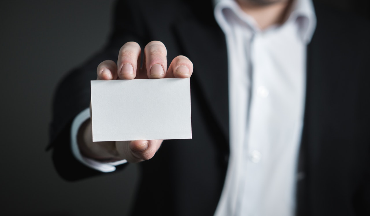 man holding an empty business card