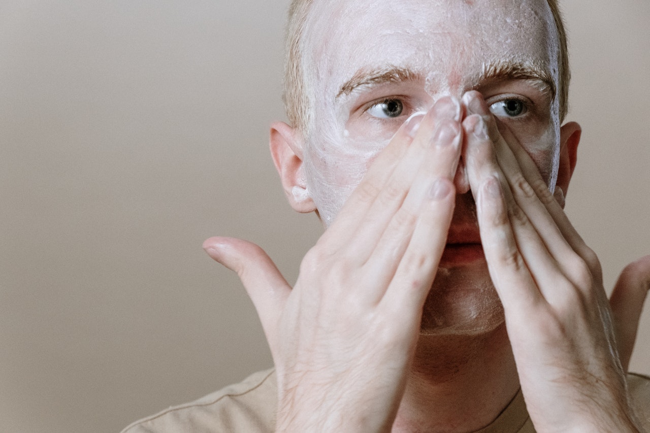 man washing his face