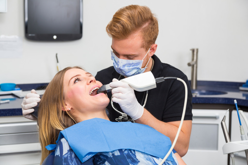 A dentist doing a dental cleaning task