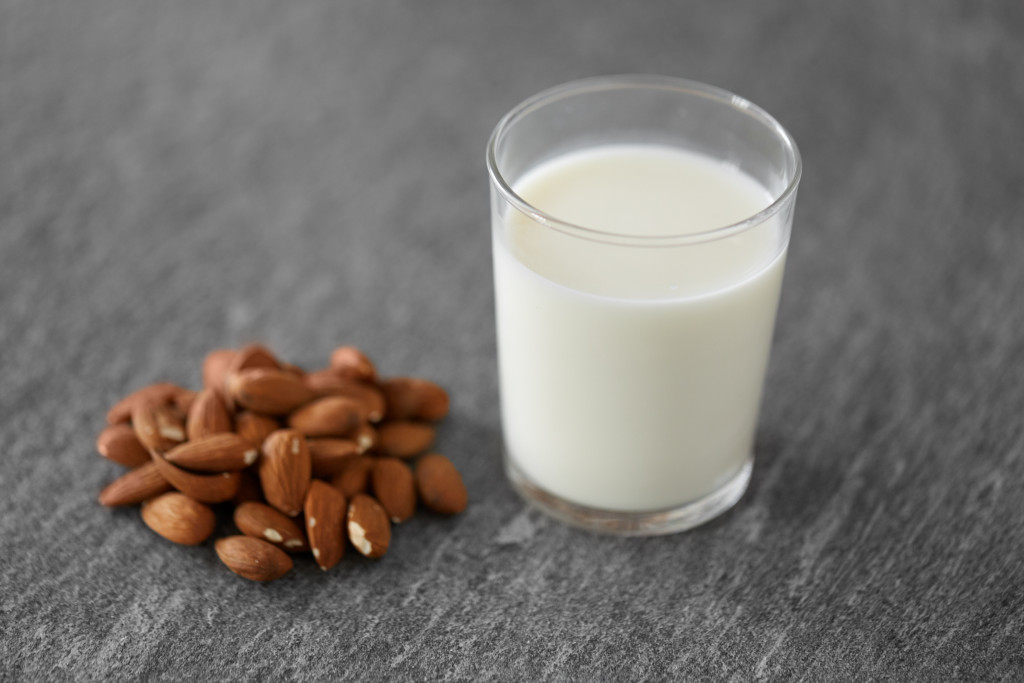 pieces of almond beside a milk