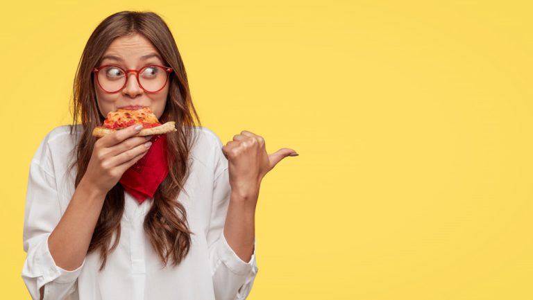 a woman eating pizza