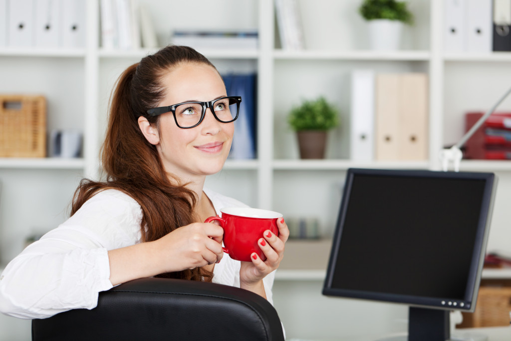 woman drinking from an earthen mug