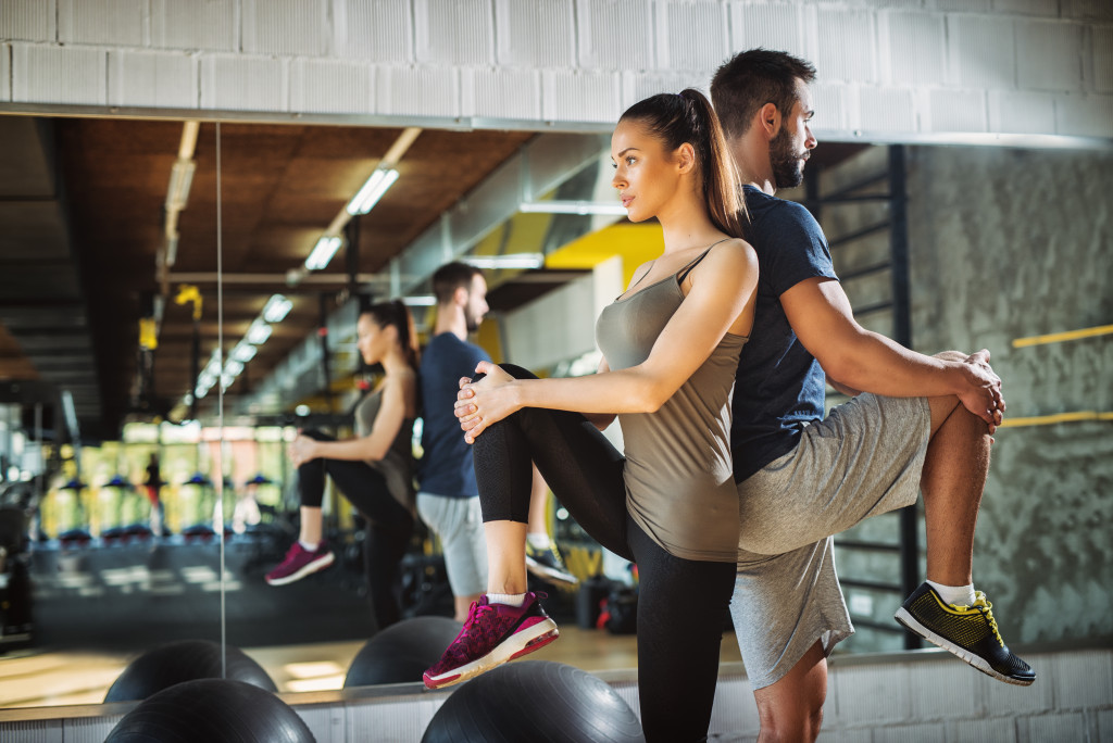 a woman exercising her back with a male partner