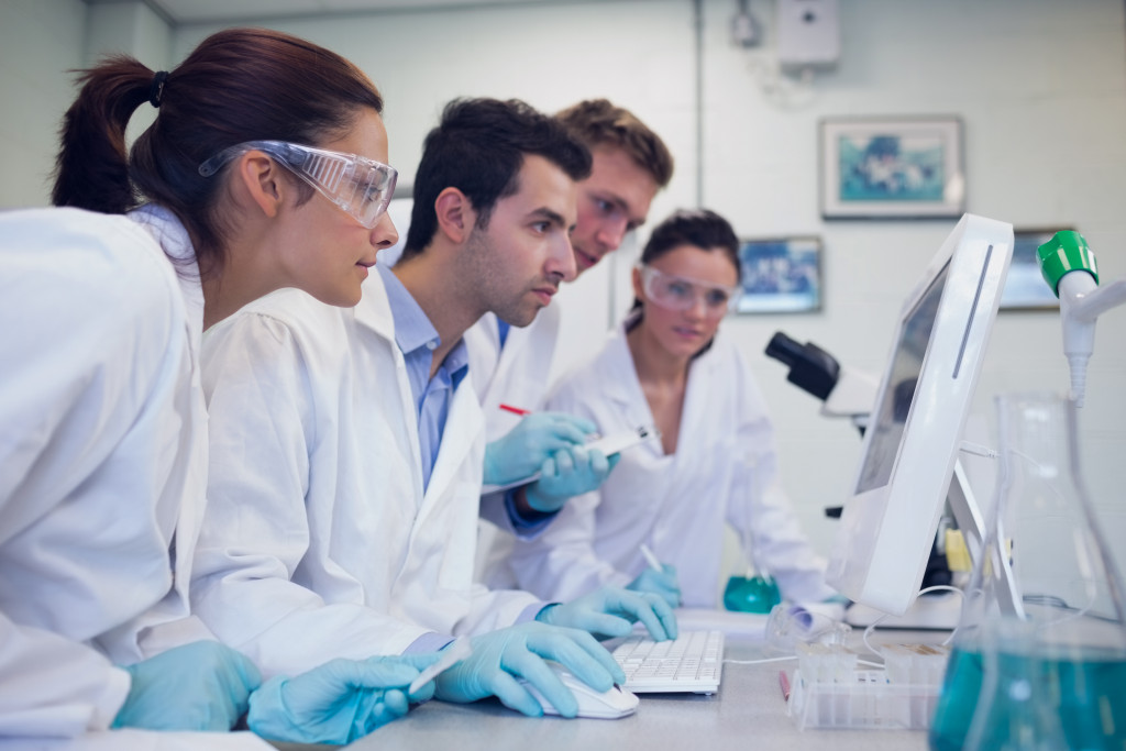 A group of researchers looking at a computer screen