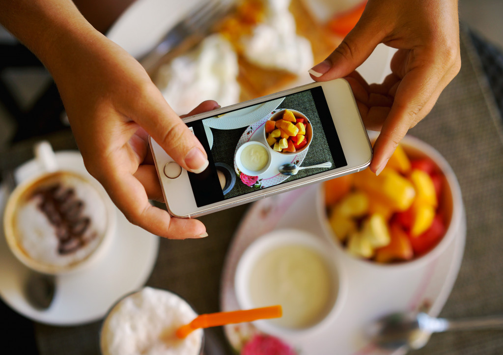 Someone using a phone to take a picture of a breakfast meal