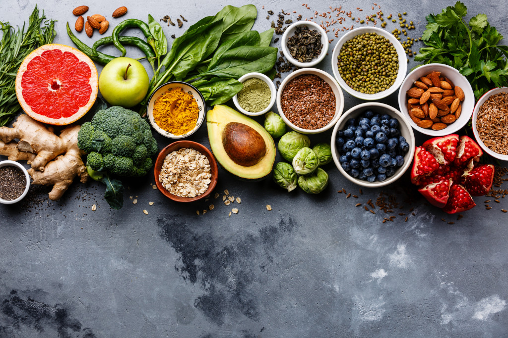 Various fruits, vegetables, seeds, and spices on a table